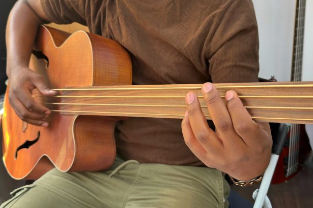 Un muzician profesionist de sex masculin nerecunoscut Gen x cântă la o chitară bas electric special fără fret